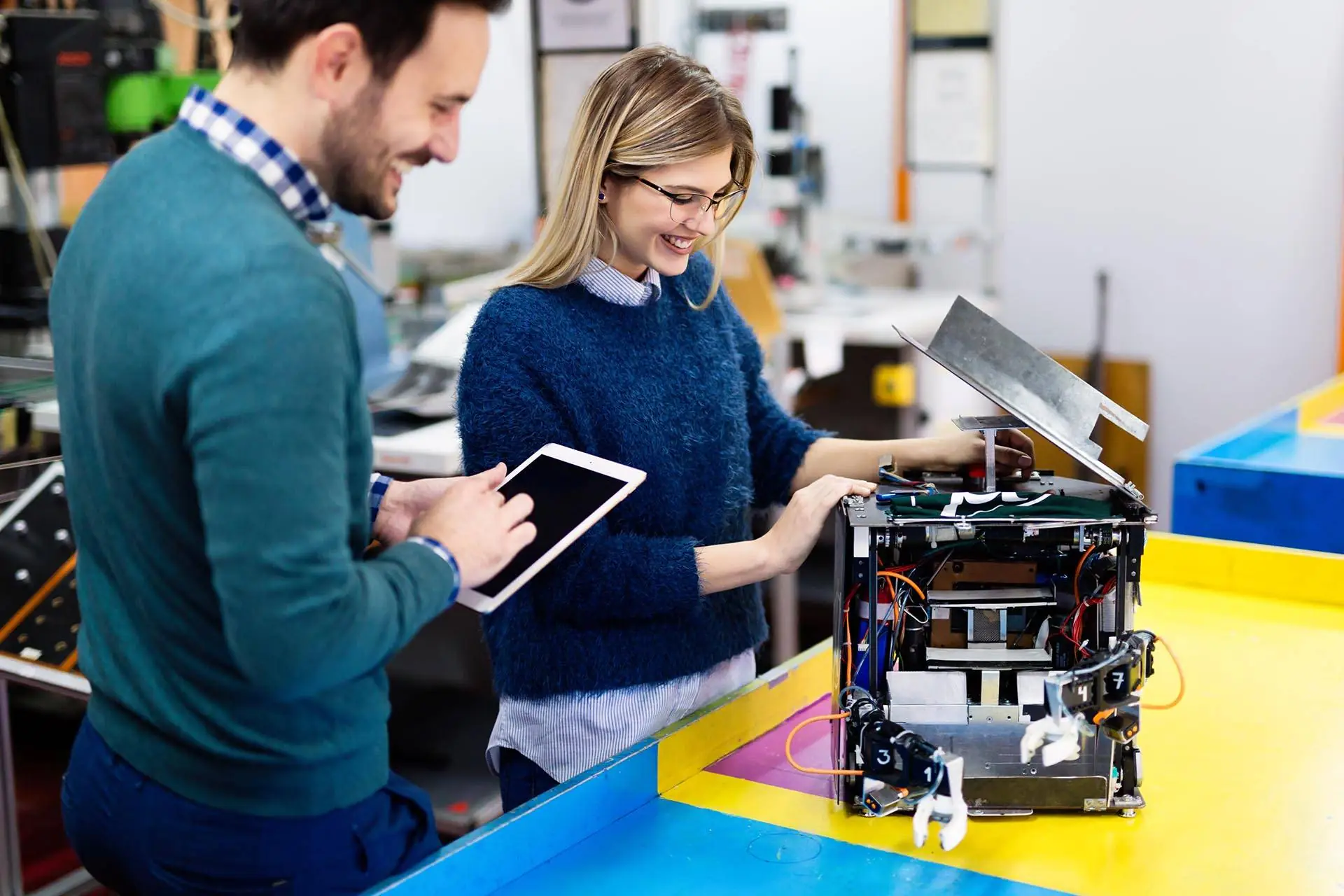 professionals working together on machine smiling in laboratory